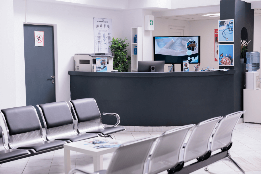 Clean and organised medical centre reception area with seating and a modern desk.